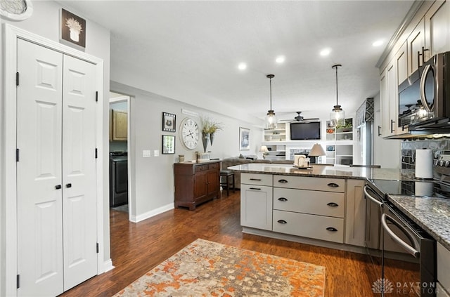 3166 Green Turtle Dr, Butler Twp, OH 45414 - kitchen with appliances with stainless steel finishes, a peninsula, open floor plan, recessed lighting, and dark stone countertops