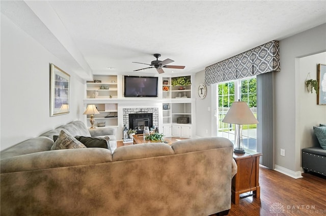 3166 Green Turtle Dr, Butler Twp, OH 45414 - living room with a ceiling fan, dark wood-type flooring, a fireplace, and built in features