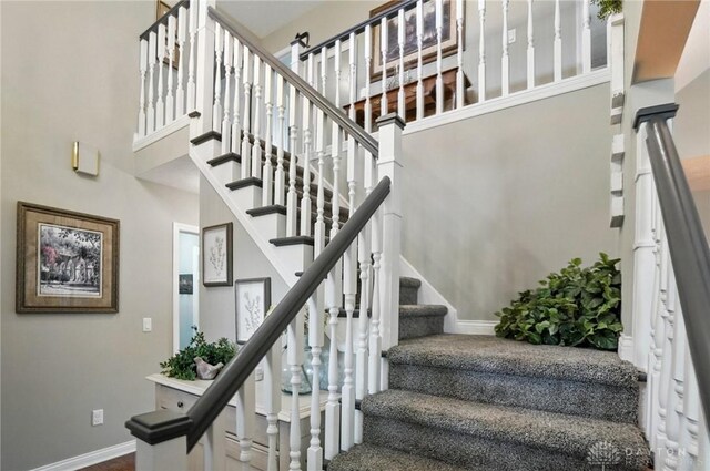 3166 Green Turtle Dr, Butler Twp, OH 45414 - stairway with baseboards and a high ceiling