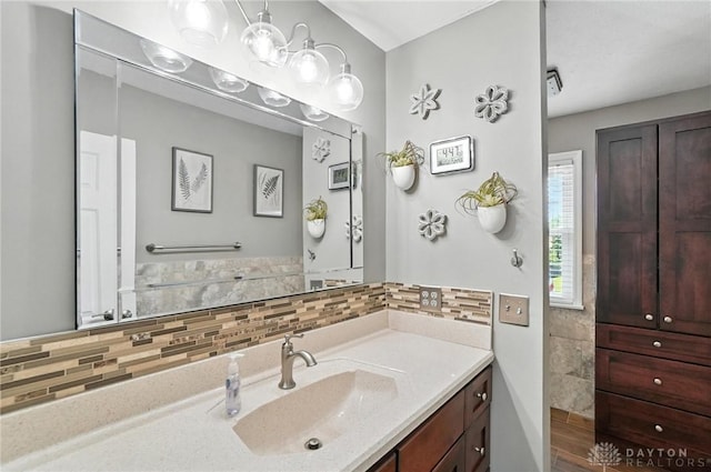 3166 Green Turtle Dr, Butler Twp, OH 45414 - bathroom featuring vanity and decorative backsplash