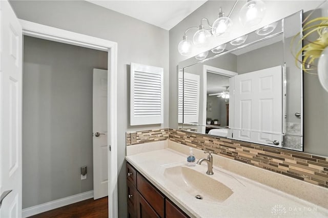 3166 Green Turtle Dr, Butler Twp, OH 45414 - bathroom featuring tasteful backsplash, vanity, wood finished floors, and ceiling fan