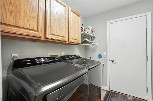 3166 Green Turtle Dr, Butler Twp, OH 45414 - washroom featuring washer and clothes dryer, cabinet space, and dark wood-type flooring