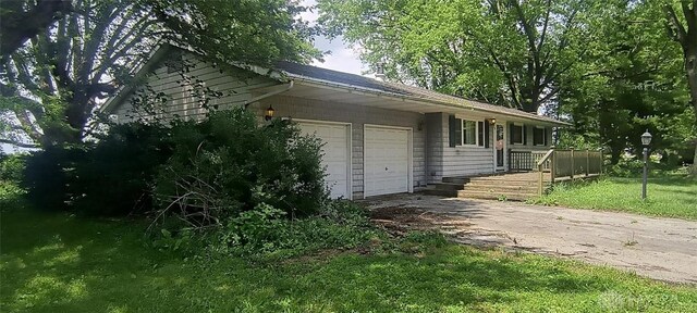 29 Elm St, Jamestown Vlg, OH 45335 - view of home's exterior with an attached garage, driveway, and a yard