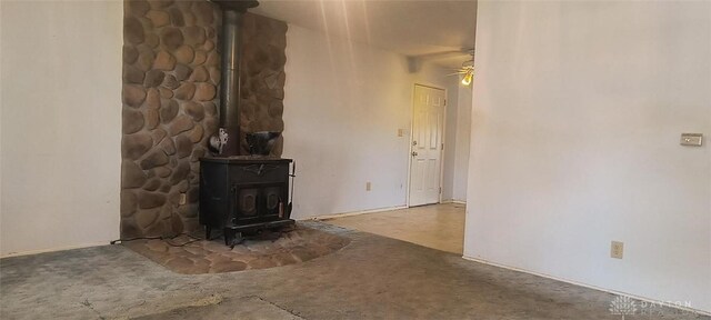 29 Elm St, Jamestown Vlg, OH 45335 - unfurnished living room with a wood stove, carpet, and ceiling fan
