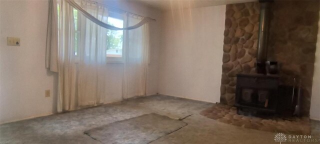 29 Elm St, Jamestown Vlg, OH 45335 - spare room with a wood stove and carpet flooring