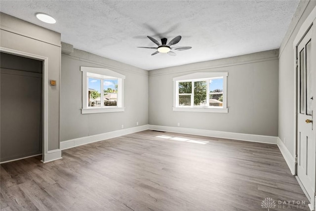 506 Virginia Ave, Troy, OH 45373 - unfurnished bedroom with a textured ceiling, wood finished floors, and ceiling fan