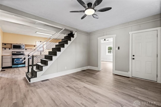 506 Virginia Ave, Troy, OH 45373 - entrance foyer featuring a ceiling fan, stairway, and light wood-style floors