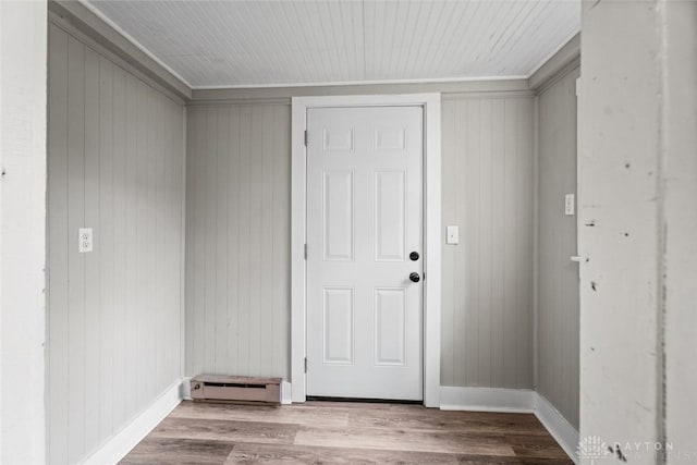 506 Virginia Ave, Troy, OH 45373 - entrance foyer featuring wood finished floors, a baseboard radiator, and wood walls