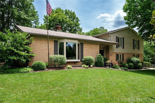 5516 Anne Ln, Washington Twp, OH 45459 - back of property with brick siding, a chimney, and a lawn