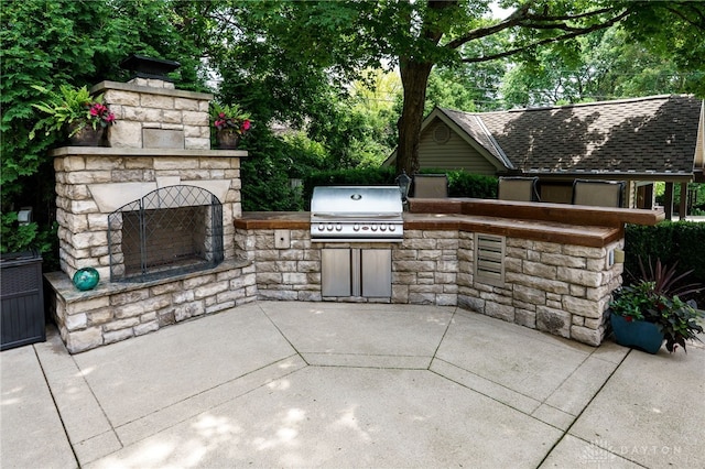 5516 Anne Ln, Washington Twp, OH 45459 - view of patio / terrace featuring an outdoor stone fireplace and exterior kitchen