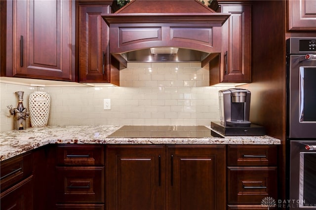 5516 Anne Ln, Washington Twp, OH 45459 - kitchen with black electric stovetop, decorative backsplash, refrigerator, light stone countertops, and double oven
