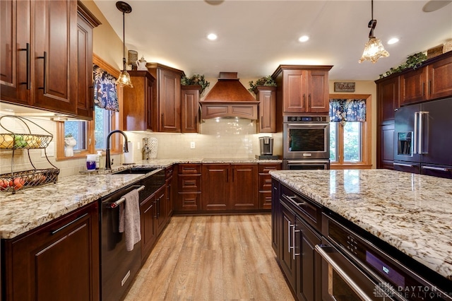 5516 Anne Ln, Washington Twp, OH 45459 - kitchen with high end fridge, dishwasher, premium range hood, healthy amount of natural light, and recessed lighting