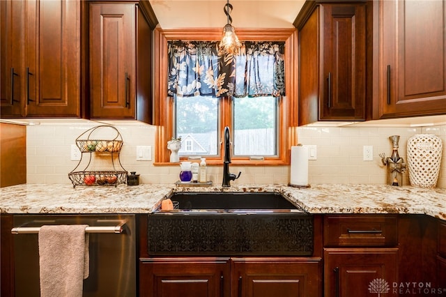 5516 Anne Ln, Washington Twp, OH 45459 - kitchen with stainless steel dishwasher, tasteful backsplash, light stone countertops, and pendant lighting