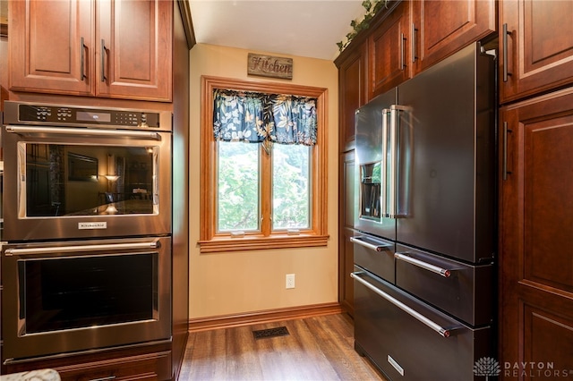 5516 Anne Ln, Washington Twp, OH 45459 - kitchen featuring high quality fridge, double oven, and wood finished floors
