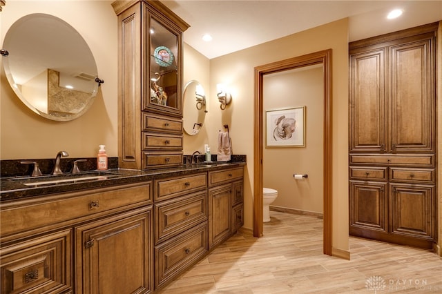 5516 Anne Ln, Washington Twp, OH 45459 - full bath with double vanity, wood finished floors, and recessed lighting