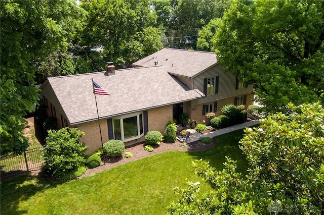 5516 Anne Ln, Washington Twp, OH 45459 - view of front of home featuring a shingled roof, brick siding, and a chimney