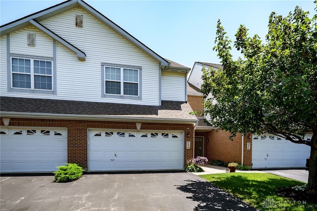 9270 Great Lakes Cir Unit 9270, Washington Twp, OH 45458 - traditional home with brick siding, asphalt driveway, roof with shingles, and an attached garage