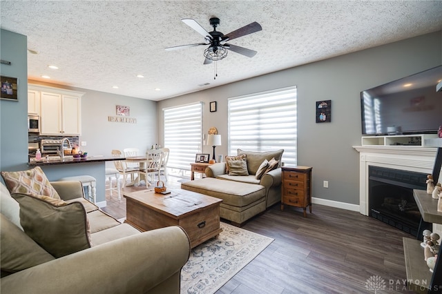 9270 Great Lakes Cir Unit 9270, Washington Twp, OH 45458 - living room featuring a textured ceiling, ceiling fan, recessed lighting, dark wood finished floors, and a fireplace