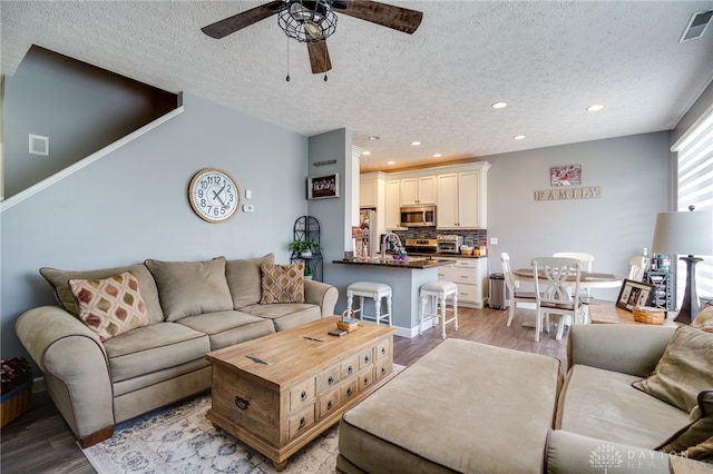 9270 Great Lakes Cir Unit 9270, Washington Twp, OH 45458 - living area featuring a textured ceiling, ceiling fan, light wood finished floors, and recessed lighting