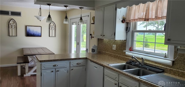 8320 N State Route 589, Fletcher, OH 45326 - kitchen featuring dishwasher, backsplash, a peninsula, dark wood finished floors, and hanging light fixtures