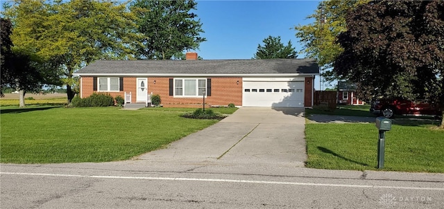8320 N State Route 589, Fletcher, OH 45326 - single story home with concrete driveway, an attached garage, a front lawn, a chimney, and brick siding