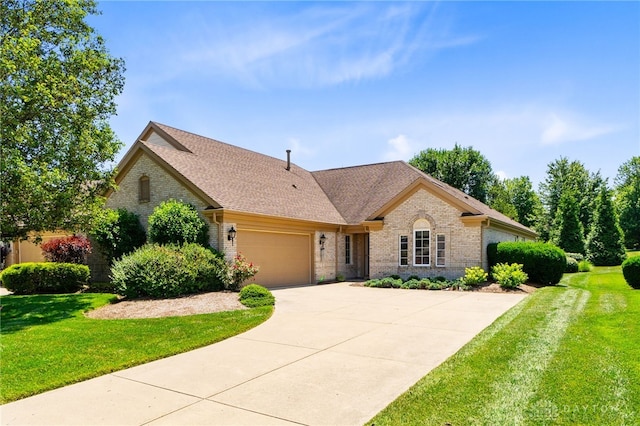 2396 Vienna Pkwy, Dayton, OH 45459 - view of front of home featuring brick siding, an attached garage, and a front yard