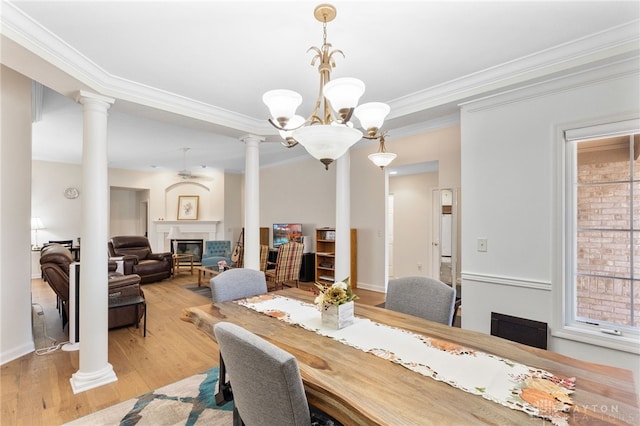 2396 Vienna Pkwy, Dayton, OH 45459 - dining space featuring ornamental molding, decorative columns, a chandelier, light wood-style floors, and a glass covered fireplace