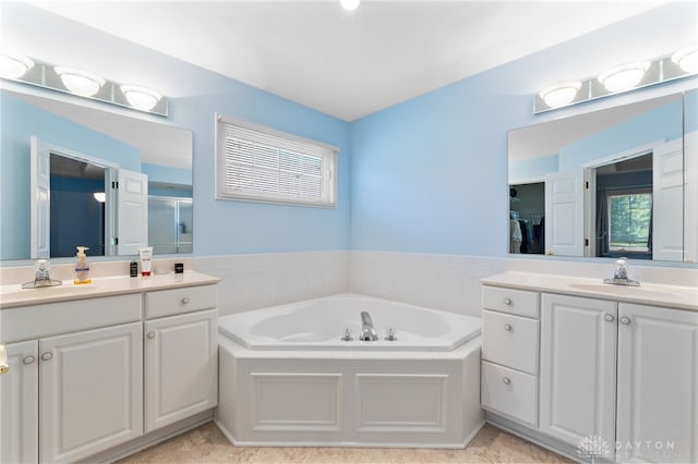 2396 Vienna Pkwy, Dayton, OH 45459 - full bath with two vanities, a bath, a shower stall, and tile patterned floors