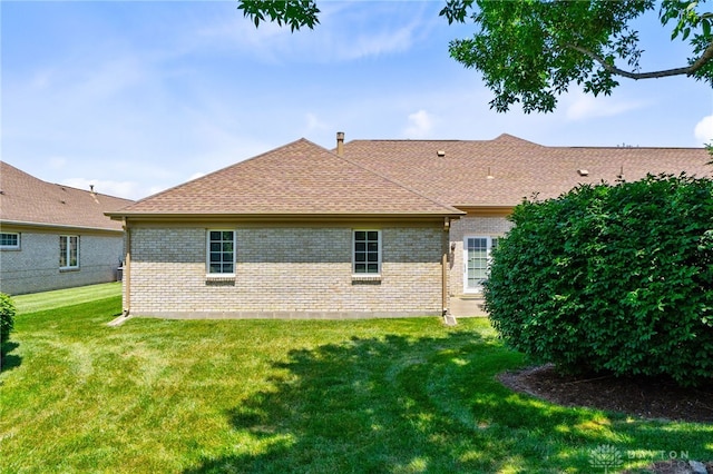 2396 Vienna Pkwy, Dayton, OH 45459 - back of property featuring brick siding, a yard, and roof with shingles