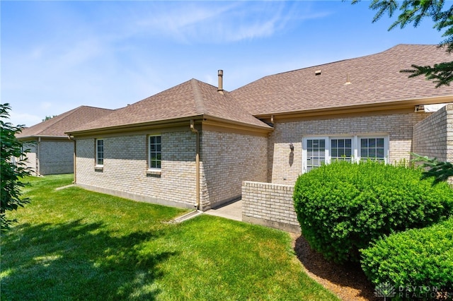 2396 Vienna Pkwy, Dayton, OH 45459 - back of house featuring brick siding, a lawn, and roof with shingles