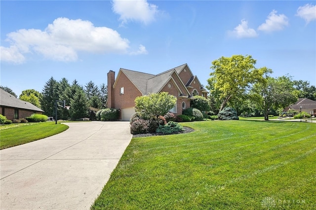 10598 Falls Creek Ln, Washington Twp, OH 45458 - view of side of home featuring a garage, a yard, driveway, and a chimney