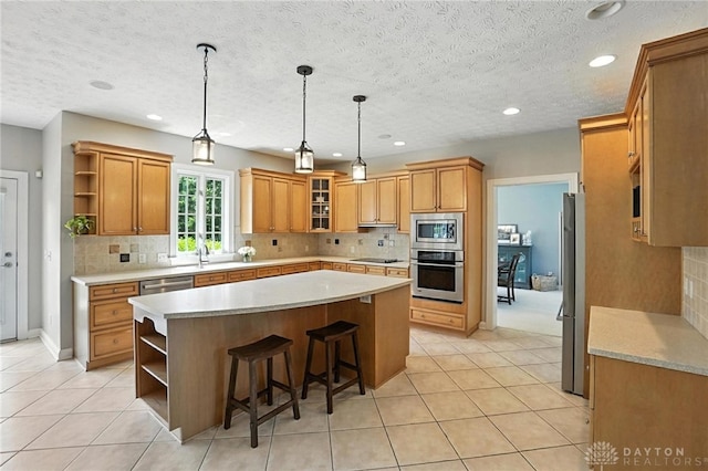 10598 Falls Creek Ln, Washington Twp, OH 45458 - kitchen with open shelves, appliances with stainless steel finishes, a center island, decorative backsplash, and recessed lighting