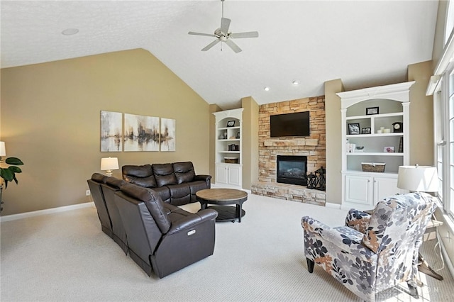 10598 Falls Creek Ln, Washington Twp, OH 45458 - living room with carpet floors, a ceiling fan, a stone fireplace, built in shelves, and high vaulted ceiling