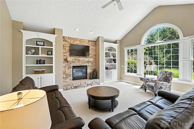 10598 Falls Creek Ln, Washington Twp, OH 45458 - carpeted living room featuring ceiling fan, vaulted ceiling, a stone fireplace, and built in shelves