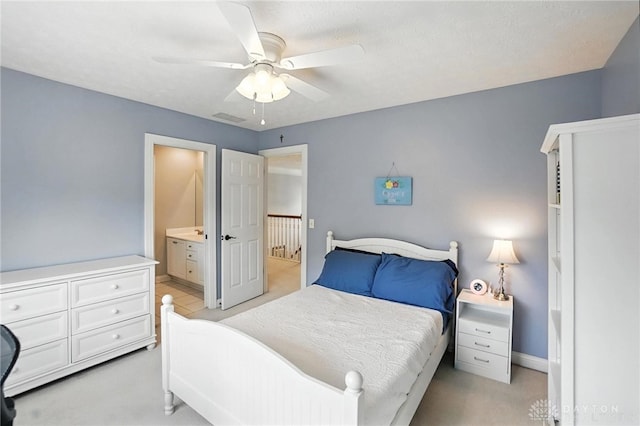 10598 Falls Creek Ln, Washington Twp, OH 45458 - bedroom with light colored carpet, ensuite bathroom, and a ceiling fan