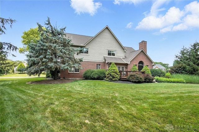 10598 Falls Creek Ln, Washington Twp, OH 45458 - view of side of property featuring a lawn, a wooden deck, and brick siding