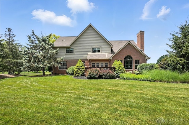 10598 Falls Creek Ln, Washington Twp, OH 45458 - rear view of house with brick siding, a yard, a chimney, and a deck