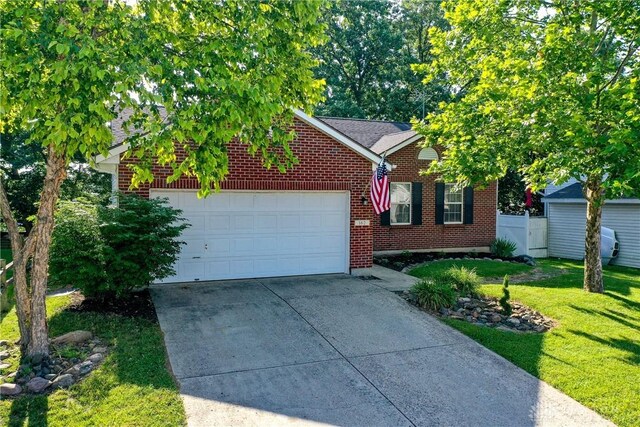 162 Choctaw Cir, Franklin, OH 45005 - view of front of home with concrete driveway, brick siding, and a garage