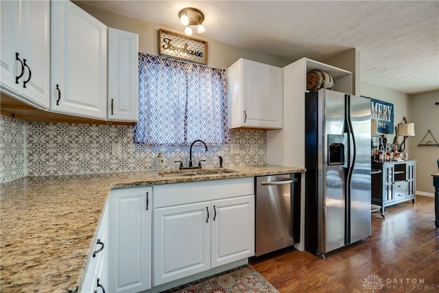 162 Choctaw Cir, Franklin, OH 45005 - kitchen with appliances with stainless steel finishes, decorative backsplash, dark wood-type flooring, a textured ceiling, and white cabinetry
