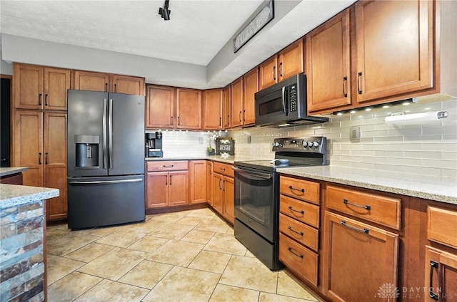 1778 Kensington Dr, Bellbrook, OH 45305 - kitchen with stainless steel refrigerator with ice dispenser, electric range, and brown cabinets