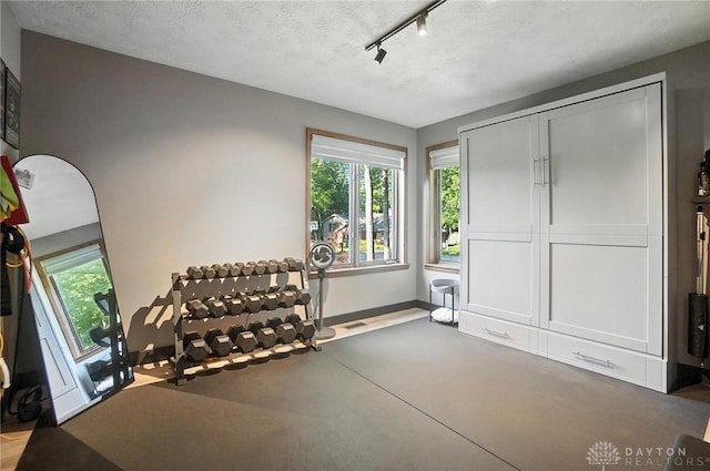 1778 Kensington Dr, Bellbrook, OH 45305 - workout area featuring healthy amount of natural light, rail lighting, and a textured ceiling