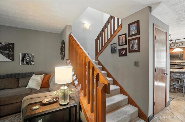 1778 Kensington Dr, Bellbrook, OH 45305 - staircase featuring tile patterned floors and baseboards