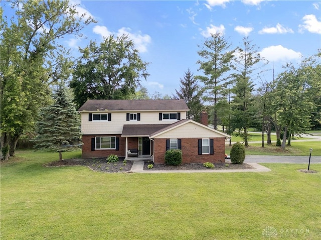 6618 Paxton Guinea Rd, Miami Twp, OH 45140 - traditional-style home with covered porch, brick siding, and a front yard