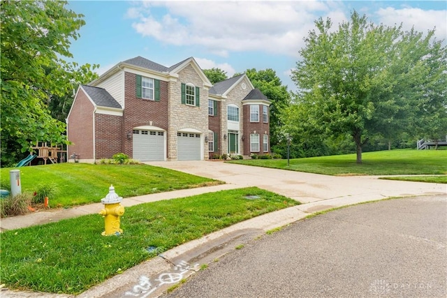 2540 Early Spring Ct, Dayton, OH 45459 - view of front facade featuring concrete driveway, a front lawn, an attached garage, brick siding, and a playground