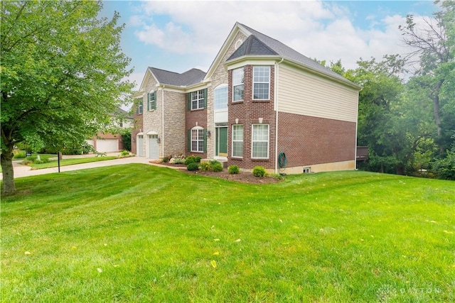 2540 Early Spring Ct, Dayton, OH 45459 - view of front of home with driveway, a front yard, brick siding, and a garage