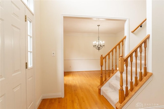 2540 Early Spring Ct, Dayton, OH 45459 - foyer featuring wood finished floors, a chandelier, stairway, and ornamental molding