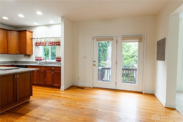 2540 Early Spring Ct, Dayton, OH 45459 - kitchen with light wood finished floors, healthy amount of natural light, brown cabinets, recessed lighting, and electric panel