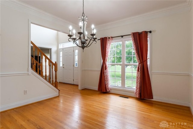 2540 Early Spring Ct, Dayton, OH 45459 - unfurnished dining area featuring crown molding, stairs, plenty of natural light, and wood finished floors
