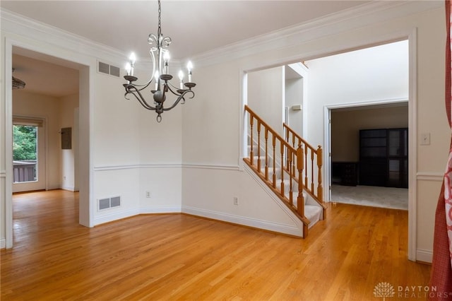 2540 Early Spring Ct, Dayton, OH 45459 - unfurnished dining area featuring light wood-type flooring, a chandelier, stairs, and ornamental molding