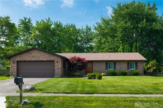 4425 E Entrada Dr, Beavercreek, OH 45431 - ranch-style house featuring an attached garage, brick siding, a front lawn, and concrete driveway